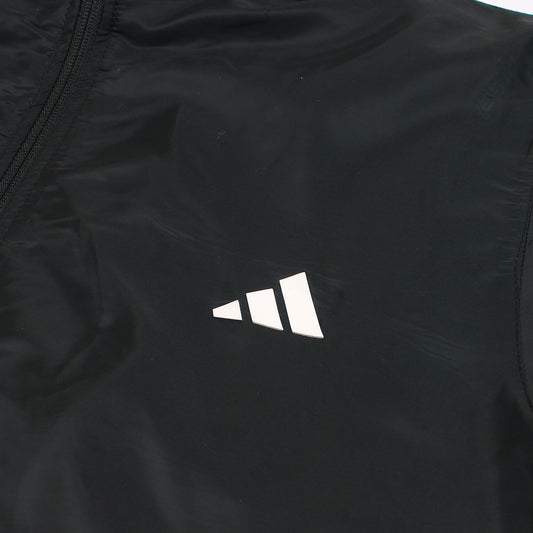 Close-up of a black jacket with a white logo on a white background