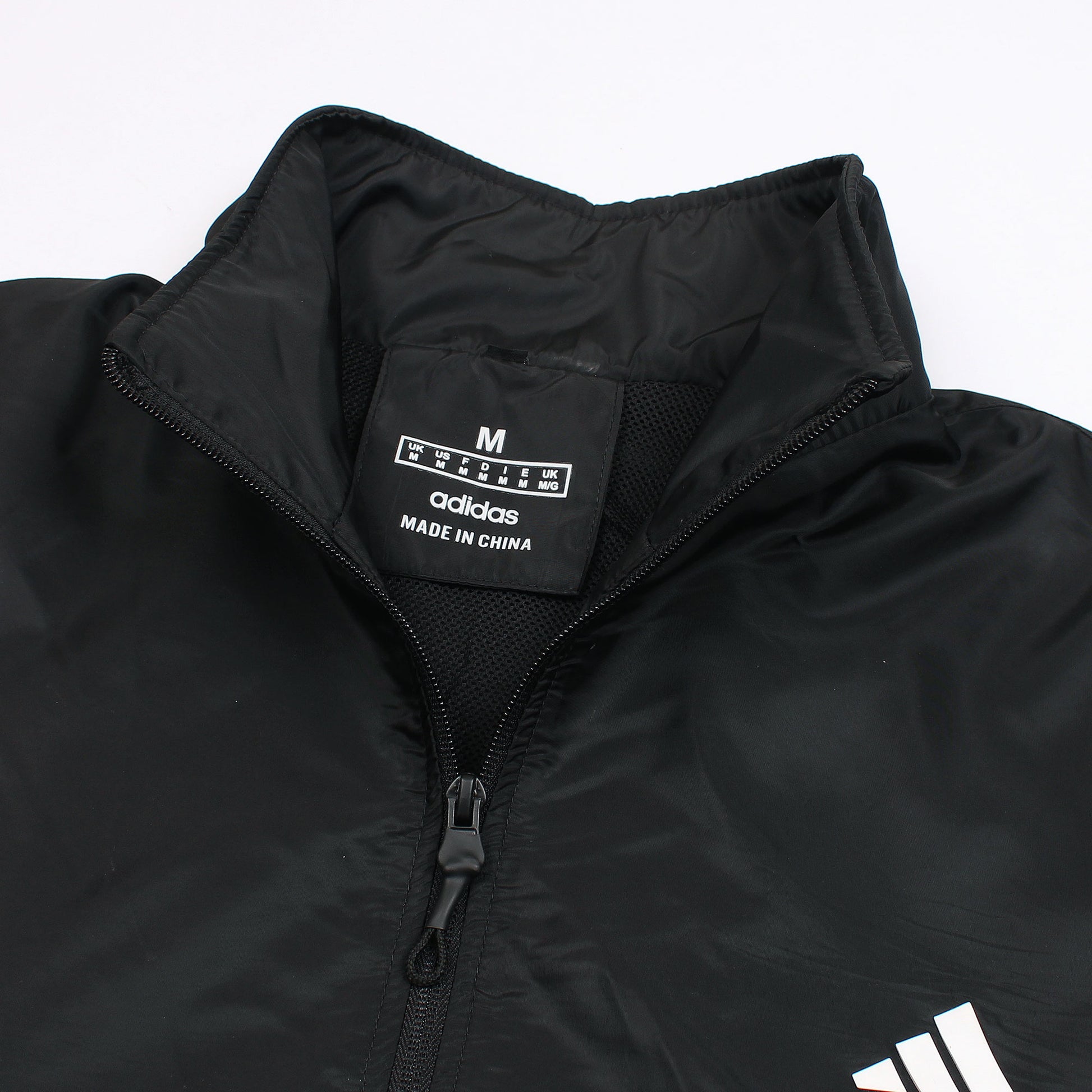Black jacket with Adidas logo and text on a white background